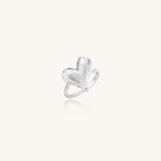 18K gold plated brass ring with intricate feather design forming a heart shape on white background.