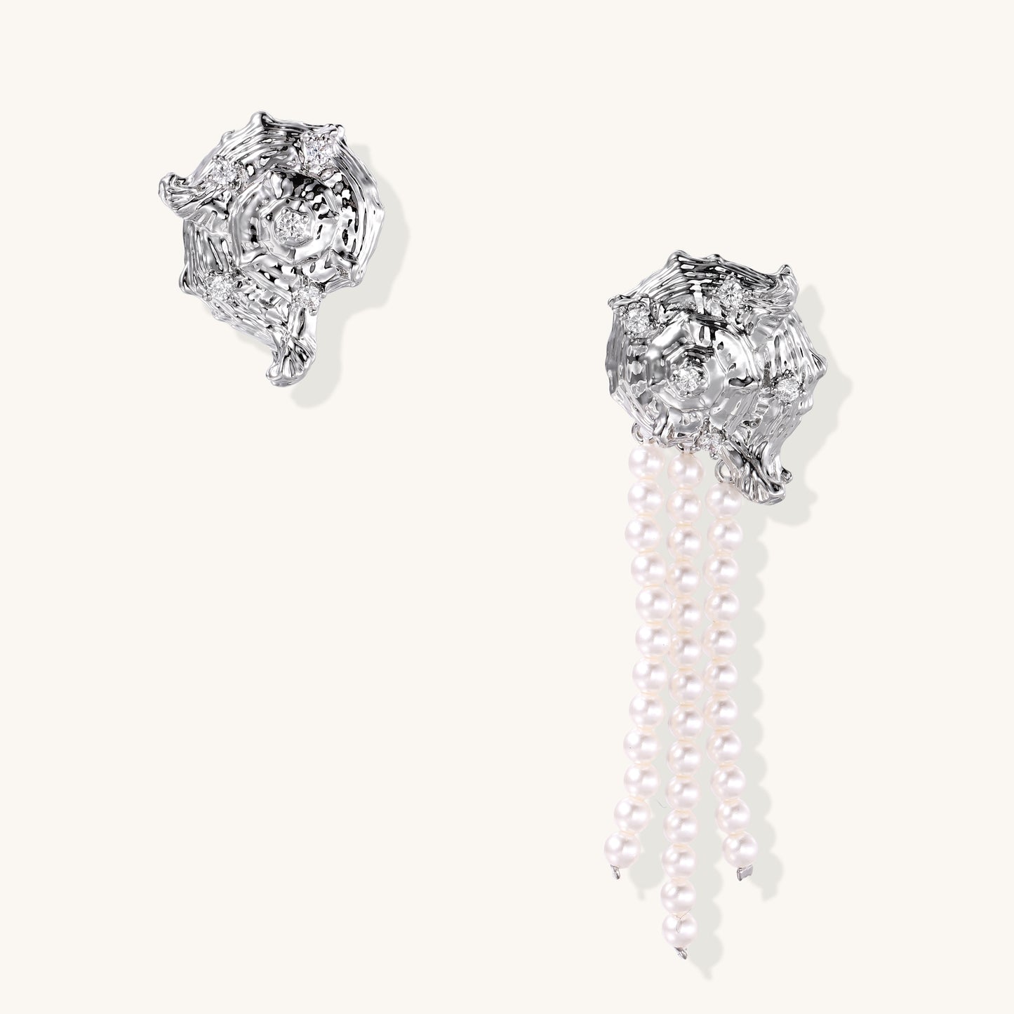 Intricate gold-plated geometric dangle earrings with zirconia stones and pearl drops on neutral background