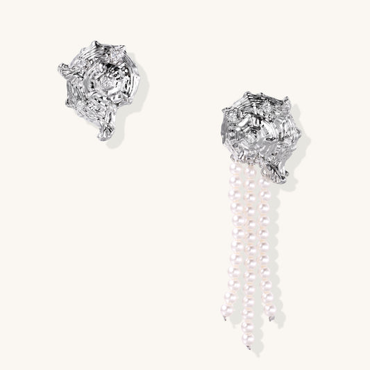 Intricate gold-plated geometric dangle earrings with zirconia stones and pearl drops on neutral background