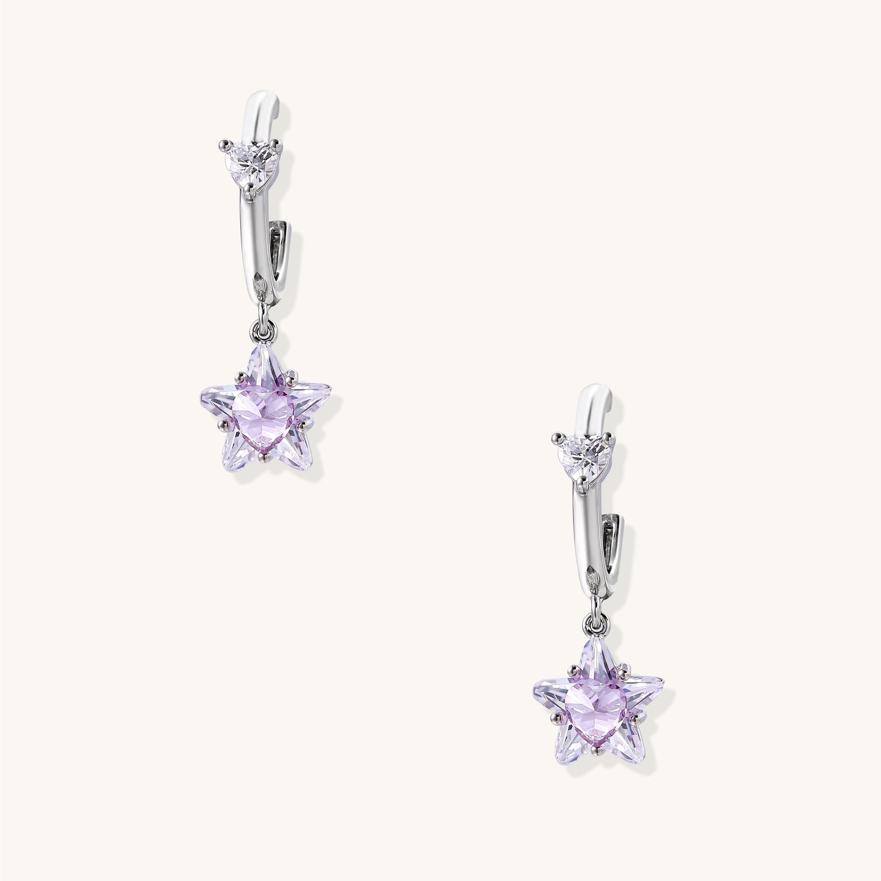 Drop earrings with purple star-shaped zirconia stones and clear teardrop accents in gold-plated brass setting