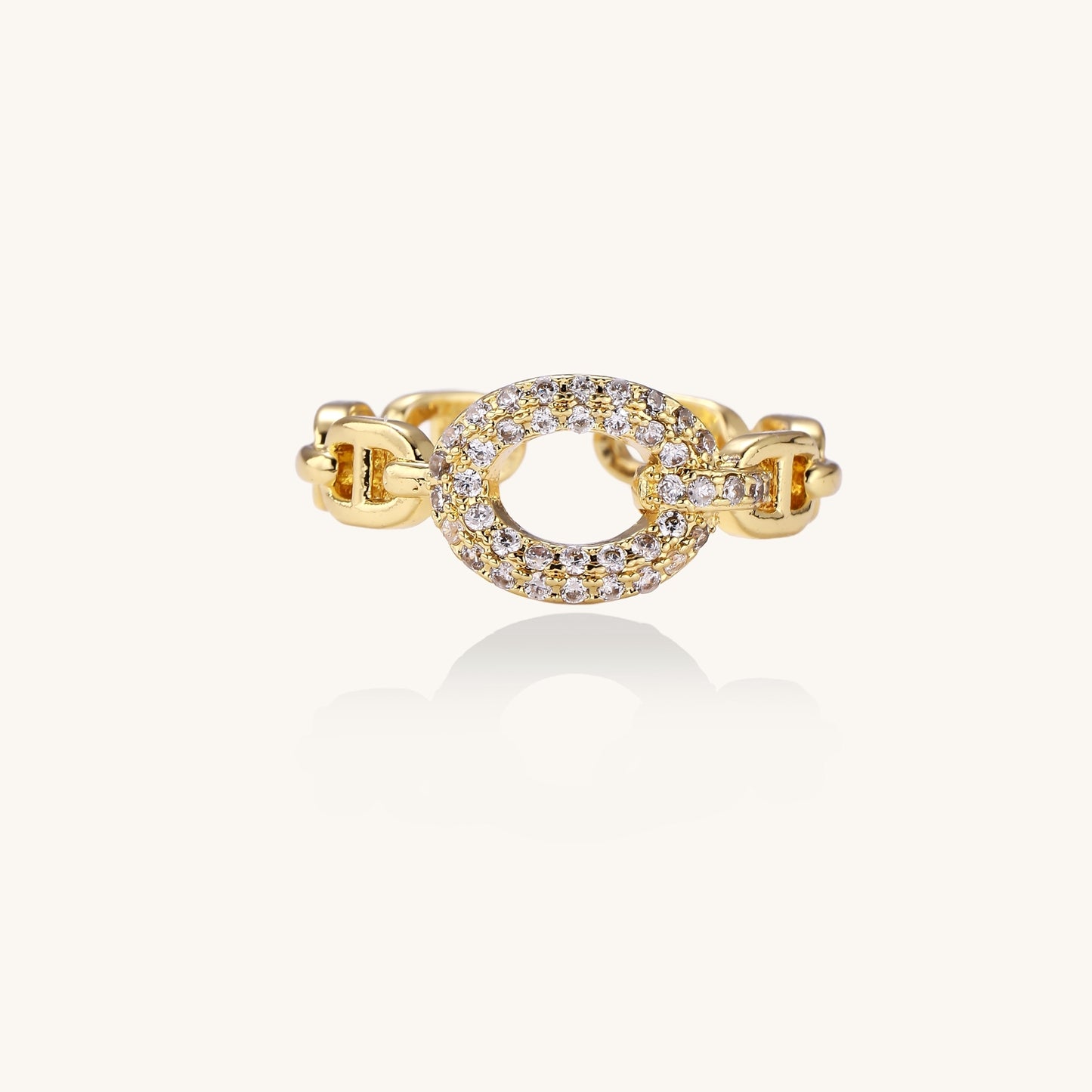 Gold-plated brass chain-link ring with cubic zirconia oval centerpiece, showing adjustable open-back design.