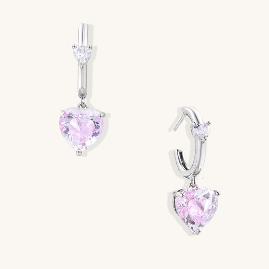 Elegant drop earrings featuring pink heart-shaped zirconia stones with clear accent gems in gold-plated settings