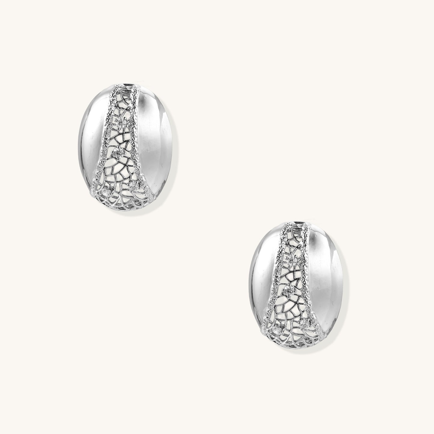 Oval gold-plated brass hoop earrings with cracked zirconia crystal pattern detail on neutral background.