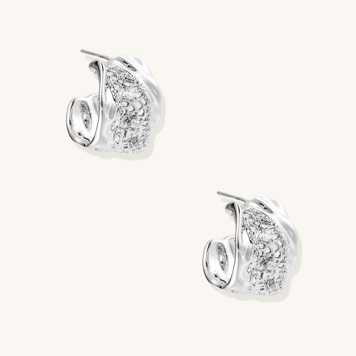 Small gold-plated brass hoop earrings with geometric lattice pattern and zirconia accents on white background.