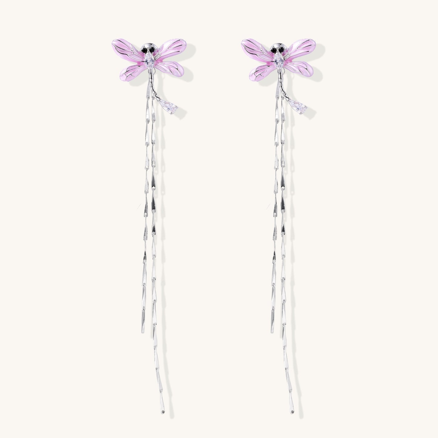 Long dangle earrings with purple dragonfly charms and crystal chains on white background, gold-plated finish.