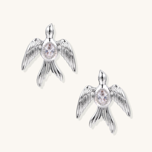 Gold-plated angel wing stud earrings with detailed feather texture and oval zirconia stones in centers