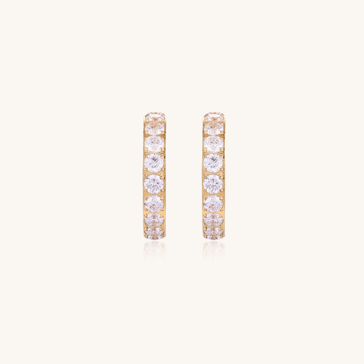 Gold-plated hoop earrings with crystal pavé and floating freshwater pearls inside the circular design.