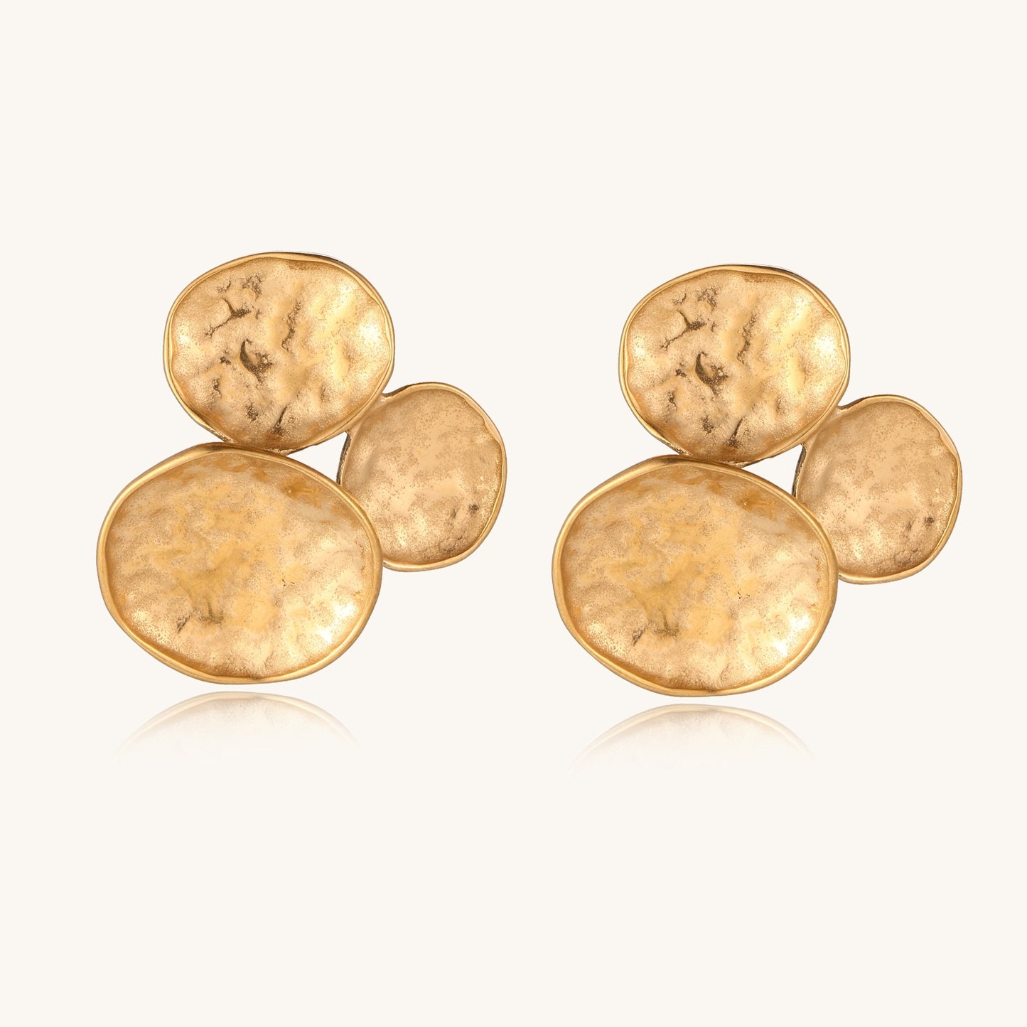 Sculptural gold-plated stainless steel earrings with three hammered oval shapes arranged in artistic cluster formation